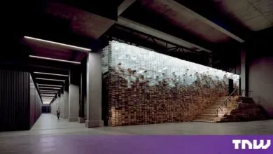 Spacious industrial facility featuring a glowing translucent wall and wooden pallets
