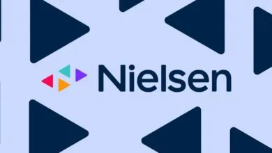 Nielsen corporate logo on light blue background with dark blue triangles