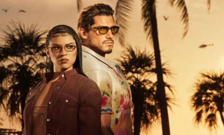 Lucia and Jason standing together against a tropical sunset background with palm trees