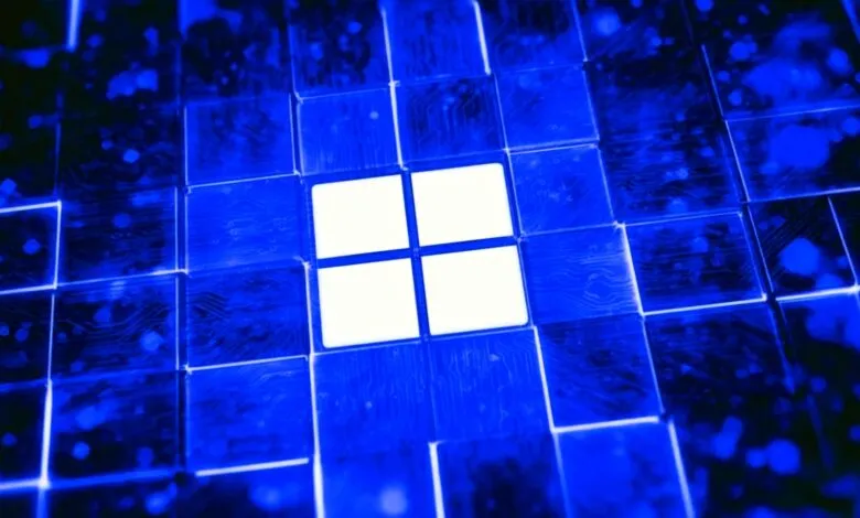 Glowing white Microsoft Windows logo centered among dark blue digital circuit board tiles.