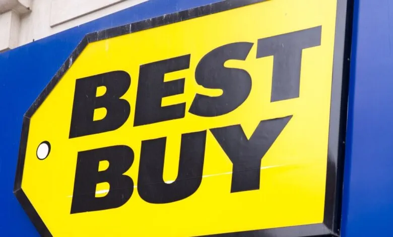 Close-up of the bright yellow and blue Best Buy retail store logo sign outdoors.