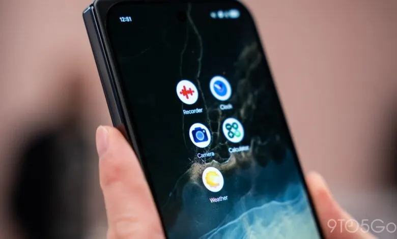 Close-up of a smartphone displaying new app icons on a dark, textured wallpaper.