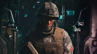 A South Korean soldier wearing combat gear and helmet stands inside a dimly lit vehicle.
