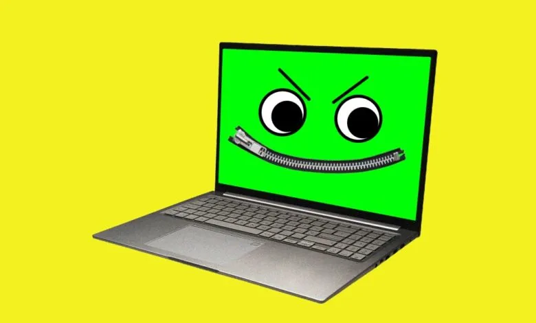 A modern laptop with a green screen displaying an angry face with a zipper mouth against a solid yellow background.