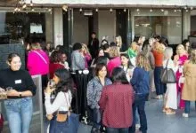 Diverse group of people networking at a lively outdoor evening cocktail reception