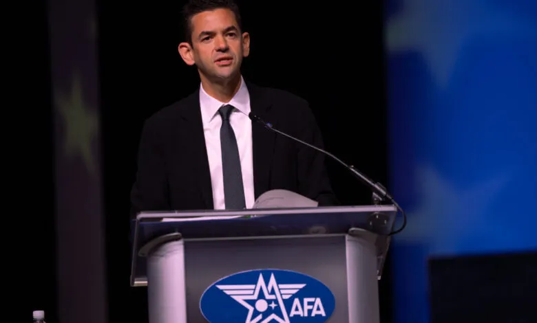 Justin Alpern speaks at a podium with an AFA logo during an official event.