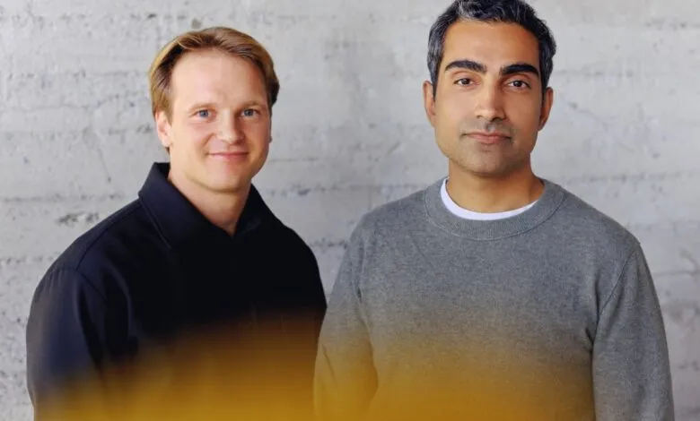 AIUC founders Rune Kvist and Rajiv Dattani stand side by side against a concrete wall.