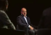 Tech investor and entrepreneur Jason Calacanis smiling on stage during a conference panel discussion