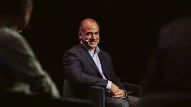 Tech investor and entrepreneur Jason Calacanis smiling on stage during a conference panel discussion