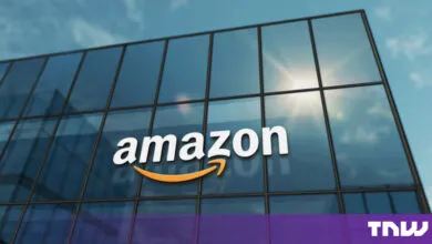 The Amazon corporate logo displayed on a modern glass building under a sunny sky