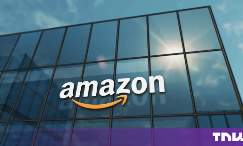 The Amazon corporate logo displayed on a modern glass building under a sunny sky