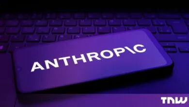 Smartphone displaying the Anthropic company logo in white text on a purple screen, resting on a laptop keyboard.