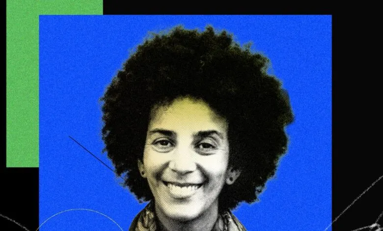 Portrait of AI researcher Timnit Gebru against a vibrant blue and black background.