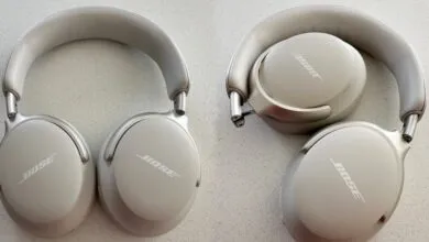 Bose QC Ultra wireless headphones in white smoke, shown unfolded and folded flat on a textured grey surface