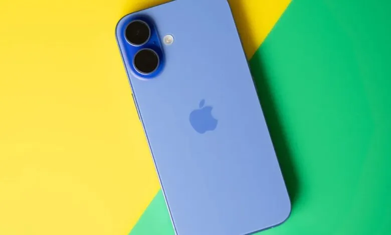 Blue iPhone back with dual vertical cameras resting on yellow and green background
