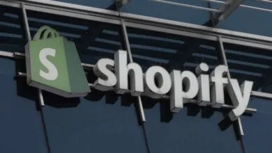 Shopify company logo mounted on a modern glass and steel building exterior