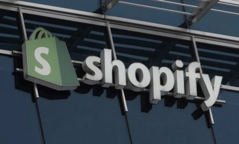 Shopify company logo mounted on a modern glass and steel building exterior