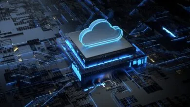 Glowing blue cloud icon hovering above a microchip on a complex dark circuit board background.