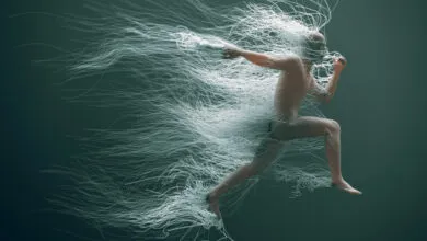 A man runs midair as countless white wires trail dynamically behind him in a greenish space.