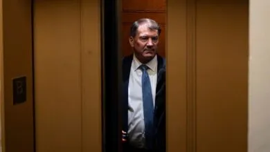 Senator Markwayne Mullin stepping through a partially open elevator door