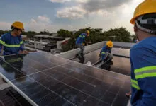 Workers install solar panels on a residential rooftop in Antipolo, Philippines, amid rising energy demand.