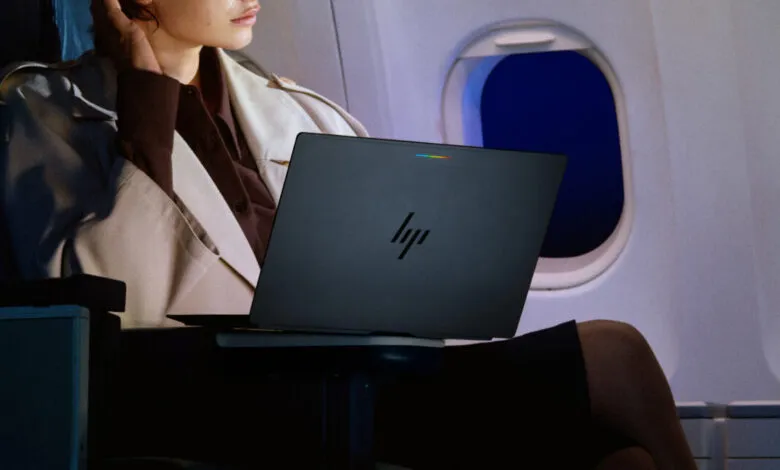 A person uses an HP laptop with a Google Chrome logo on an airplane during flight.
