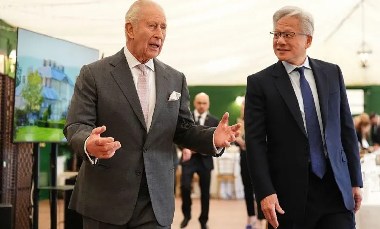 King Charles III and Nvidia CEO Jensen Huang talking inside a marquee.