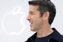 Apple CEO John Ternus delivers a keynote address on stage in front of the glowing Apple logo.