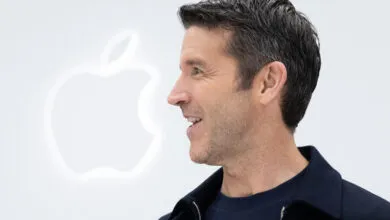 Apple CEO John Ternus delivers a keynote address on stage in front of the glowing Apple logo.