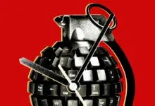 A grenade shaped like a computer keyboard against a bright red background.