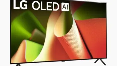 LG OLED AI television displaying a vibrant abstract image with green, orange, and white textures.