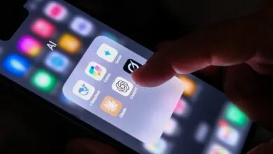 A finger interacting with an AI app folder on a smartphone screen showing ChatGPT, Gemini, and Claude.