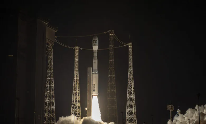Vega-C rocket launching at night, surrounded by lightning protection towers