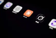 Close-up of a smartphone screen displaying various AI application logos, including Claude and ChatGPT.