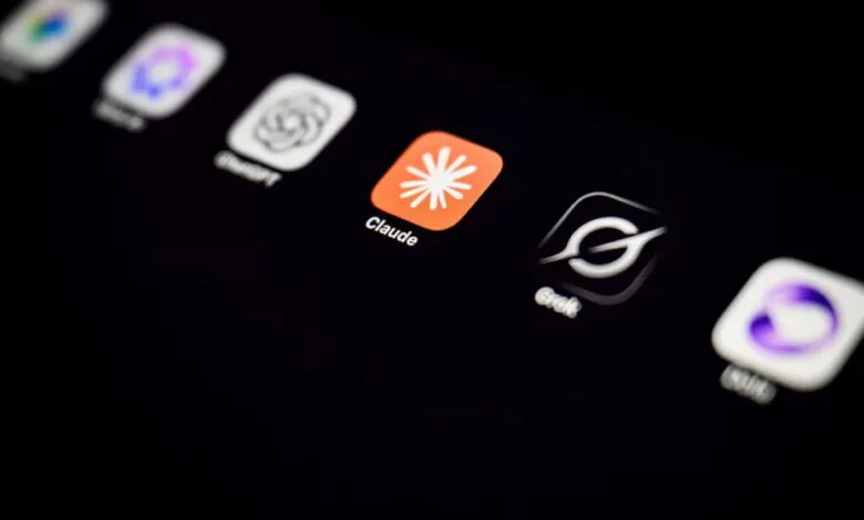 Close-up of a smartphone screen displaying various AI application logos, including Claude and ChatGPT.