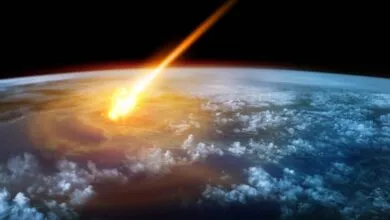 A fiery asteroid streaks across the dark sky and impacts Earth, creating a massive explosion.