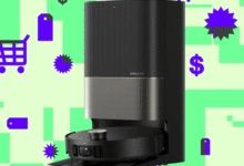 Dreame X50 Ultra robot vacuum docked in its black and silver station on green background