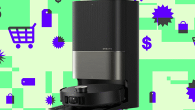 Dreame X50 Ultra robot vacuum docked in its black and silver station on green background