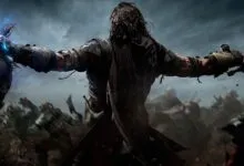 Talion holding a glowing head and a sword amidst a battlefield in Shadow of Mordor