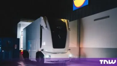 An autonomous Einride cabless electric truck parked at a Lidl store at night.