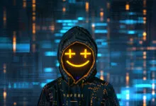 A hooded hacker figure wearing a glowing yellow smiley face mask against a digital blue background.