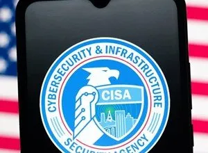 CISA logo displayed on a smartphone screen against an American flag background