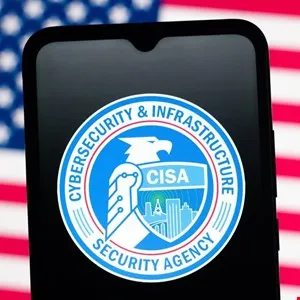 CISA logo displayed on a smartphone screen against an American flag background