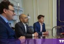 Tech leaders Dario Amodei, Demis Hassabis, and Sam Altman seated together at a conference table