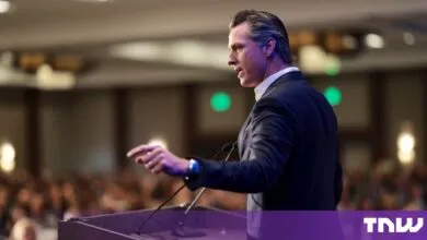 California Governor Gavin Newsom speaking passionately at a podium before a seated audience