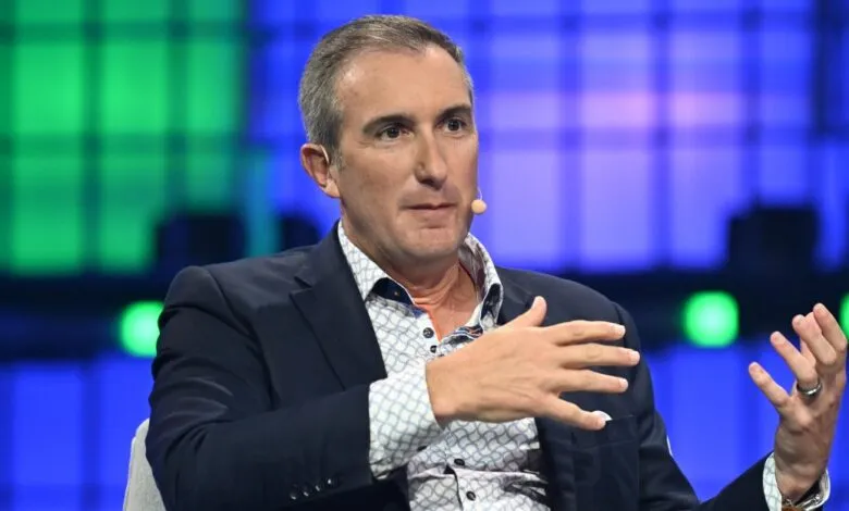 Tech executive speaking on stage with blue and green background