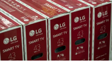 A row of red and white LG 43-inch Smart TV boxes lined up neatly in storage.