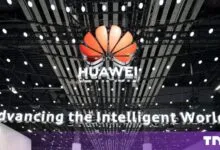 Illuminated Huawei logo displayed below a modern ceiling structure at MWC 24
