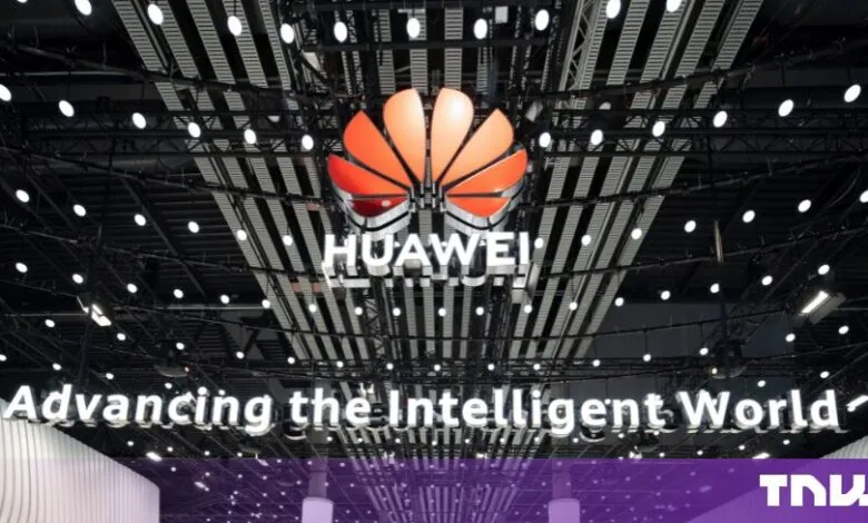 Illuminated Huawei logo displayed below a modern ceiling structure at MWC 24