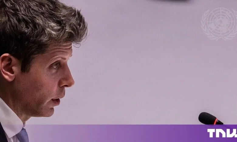 Sam Altman in profile view speaking into a microphone at an official meeting.